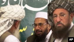 Hafiz Mohammad Saeed, center, chief of Jamaat-ud-Dawwa and founder of Lashkar-e-Taiba, talks with religious leaders prior to his news conference in Rawalpindi, Pakistan on Wednesday, April 4, 2012.
