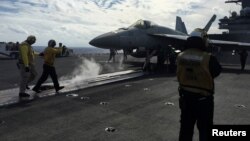 FILE - U.S. Navy aircraft carrier USS Ronald Reagan conducts military drills during Keen Sword, a joint field-training exercise involving U.S. military, Japan Maritime Self-Defense Force personnel and Royal Canadian Navy, Nov. 3, 2018. 