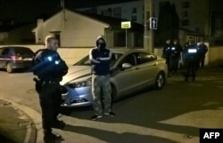 Police officers search near the house of the suspected attacker who opened fire on police on Paris' Champs Elysees, in Chelles on April 21, 2017.