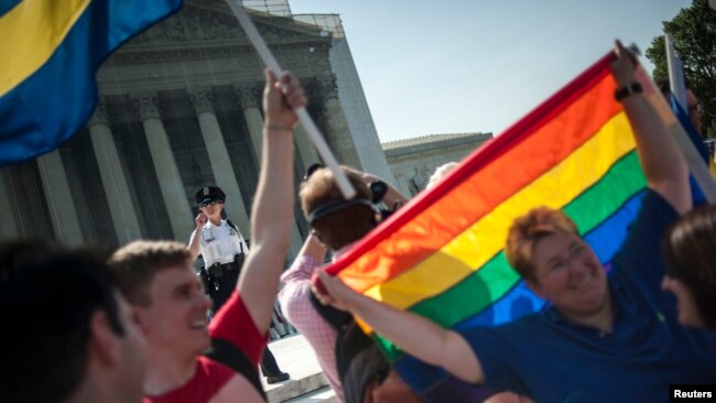 FILE - Gay activists are seen at a rally at the U.S. Supreme Court in Washington, D.C., June 26, 2013.