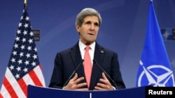 U.S. Secretary of State John Kerry speaks at a news conference during a NATO foreign ministers meeting in Brussels December 3, 2013.