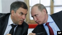 FILE - Then-Russian Prime Minister Vladimir Putin, right, speaks with his then-Chief of Staff Vyacheslav Volodin during a meeting of officials in Pskov in May 2011. Volodin is on a list of Russian officials facing U.S. sanctions. 
