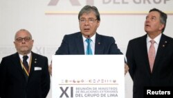 Colombia's Foreign Affairs Minister Carlos Holmes Trujillo reads the final statement after a meeting of the Lima Group in Bogota, Colombia, Feb. 25, 2019.