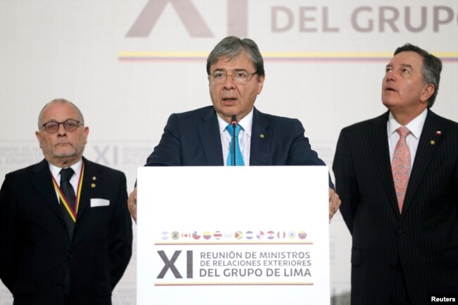 Colombia's Foreign Affairs Minister Carlos Holmes Trujillo reads the final statement after a meeting of the Lima Group in Bogota, Colombia, Feb. 25, 2019.