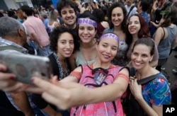 Women pose for a group photo during a protest against Jair Bolsonaro, the presidential front-runner, and far-right congressman, in Sao Paulo, Brazil, Sept. 29, 2018.