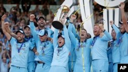 England's captain Eoin Morgan raises the trophy after winning the Cricket World Cup final match between England and New Zealand at Lord's cricket ground in London, Sunday, July 14, 2019. England won after a super over after the scores were tied after 50 