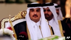 FILE- Qatar's Emir Sheikh Tamim bin Hamad Al-Thani attends a Gulf Cooperation Council summit in Doha, Qatar, Dec. 9, 2014.