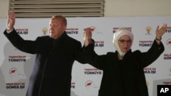 Turkey's President and ruling Justice and Development Party, or AKP, leader Recep Tayyip Erdogan, left, and his wife Emine, greet supporters after the results of the local elections were announced in Ankara, Turkey, early Monday, April 1, 2019.