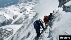 FILE - A team of mountaineers is seen climbing Mount Everest.