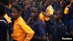 FILE - Students arrive for class at the Every Nation Academy private school in the city of Makeni in Sierra Leone, April 20, 2012.