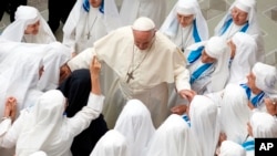 Pope Francis is greeted by a group of nuns during his weekly general audience in the Pope Paul VI hall at the Vatican, Wednesday, Aug. 22, 2018. (AP Photo/Andrew Medichini)