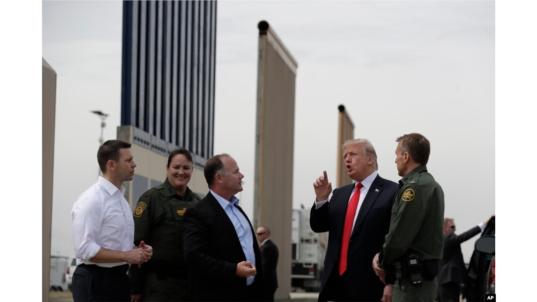 FILE - President Donald Trump reviews border wall prototypes in San Diego, March 13, 2018.