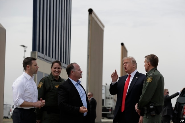 President Donald Trump reviews border wall prototypes, March 13, 2018, in San Diego.