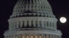 FILE - The moon rises behind the U.S. Capitol Dome in Washington, Dec. 30, 2012.