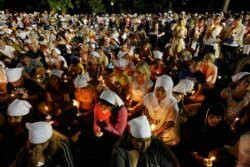 FILE - Sikhs and members of the community attend a vigil in Oak Creek, Wisconsin, Aug.7, 2012.