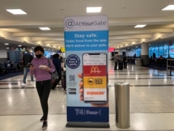 Many shops at New York’s JFK airport remain shuttered but some outlets are trying to drum up business. (Jamie Dettmer/VOA)