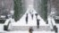 People walk during heavy snowfall in Retiro park in Madrid, January 8, 2021.