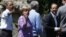 U.S. President Barack Obama, Germany's Chancellor Angela Merkel and French President Francois Hollande (L to R) face the media as the G8 leaders gather for a family photo at the G8 Summit at Camp David, Maryland, May 19, 2012