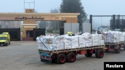 Trucks carrying aid through the Rafah border crossing, on the Egyptian side, in Rafah, Egypt, February 10, 2026.