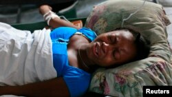 A Haitian infected with cholera grimaces in pain in a clinic set up by the International Red Cross in Port-au-Prince December 11, 2010.