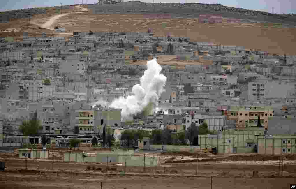 Smoke rises following a strike in Kobani, Syria, during fighting between Syrian Kurds and the militants of Islamic State group, Oct. 19, 2014.