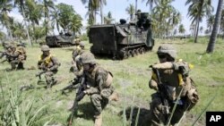 U.S. Marines take their position during a joint amphibious assault exercise with their Indonesian counterparts on Banongan beach in Situbondo, East Java, Indonesia, June 5, 2012. 