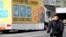 FILE - A truck with a public awareness notice on the omicron coronavirus variant moves along a busy shopping street, in Tokyo, Japan, Jan. 28, 2022.