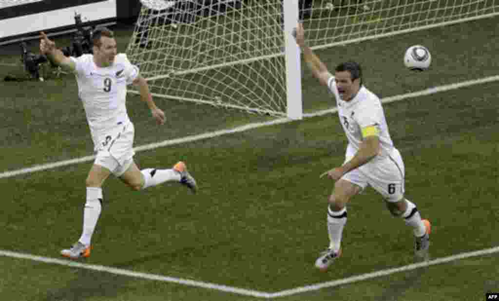 New Zealand's Shane Smeltz, left, celebrates with his teammate Ryan Nelsen after scoring during the World Cup group F soccer match between Italy and New Zealand at Mbombela Stadium in Nelspruit, South Africa, Sunday, June 20, 2010. (AP Photo/Michael Soh