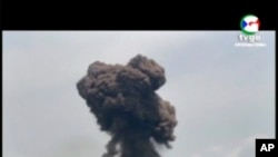 This TVGE image made from video shows smoke rising over the blast site at a military barracks in Bata, Equatorial Guinea, March 7, 2021. 