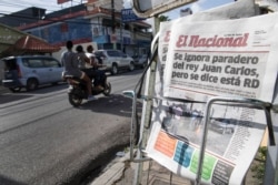 A newsrack displays copies of El Nacional newspaper with a page one headline that reads in Spanish: "The whereabouts of King Juan Carlos are unknown, but it is said that he is in the DR," Aug. 4, 2020.