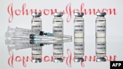 (FILES) This file illustration photo taken on November 17, 2020 shows vials with Covid-19 Vaccine stickers attached and syringes with the logo of US pharmaceutical company Johnson & Johnson. - Pharmaceuticals giant Johnson & Johnson on February 4,…