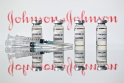 This file illustration photo taken on Nov 17, 2020 shows vials with Covid-19 Vaccine stickers attached and syringes with the logo of U.S. pharmaceutical company Johnson &; Johnson.