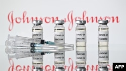 (FILES) This file illustration photo taken on November 17, 2020 shows vials with Covid-19 Vaccine stickers attached and syringes with the logo of US pharmaceutical company Johnson & Johnson. - Pharmaceuticals giant Johnson & Johnson on February 4,…