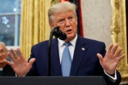 FILE - President Donald Trump speaks during a ceremony in the Oval Office of the White House, Oct. 8, 2019.