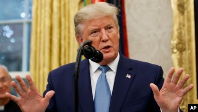 President Donald Trump speaks during a ceremony in the Oval Office of the White House, Oct. 8, 2019.