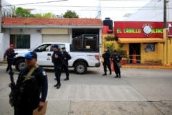 Police cordon off the White Horse nightclub (El Caballo Blanco in Spanish), the scene of a Tuesday night attack that killed more than two dozen staff and patrons, as they wait for federal investigators to arrive, in Coatzacoalcos, Veracruz state,…