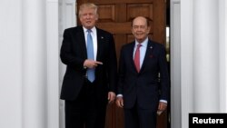 U.S. President-elect Donald Trump stands with Wilbur Ross after their meeting at Trump National Golf Club in Bedminster, New Jersey, U.S., Nov. 20, 2016. 