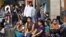 Women from India's northeastern states wait with their baggage to board trains home, at a railway station in Bangalore, India, August 16, 2012.