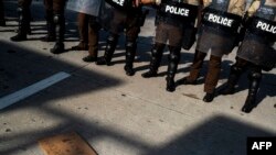 A placard reading "Freedom or Death" is seen on the road in front of a row of police officers during a rally in response to the death of George Floyd while in police custody in Minneapolis, in Miama, Florida, June 1, 2020.