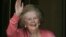 Former British Prime Minister Margaret Thatcher, gestures to members of the media as she stands on her house doorstep, following her return home from hospital, in central London, June 29, 2009.