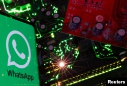 FILE - A smartphone with a displayed WhatsApp logo is placed on a computer motherboard in this illustration taken February 23, 2023. (REUTERS/Dado Ruvic/Illustration/File Photo)