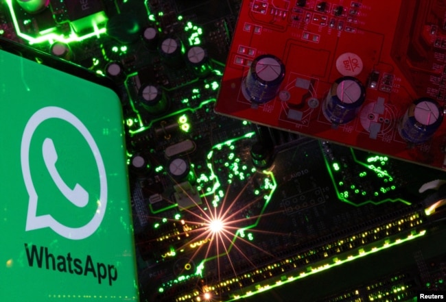 FILE - A smartphone with a displayed WhatsApp logo is placed on a computer motherboard in this illustration taken February 23, 2023. (REUTERS/Dado Ruvic/Illustration/File Photo)