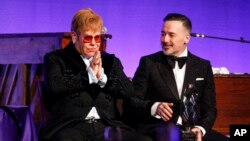 Elton John, left, and David Furnish attend the Elton John AIDS Foundation's 17th annual "An Enduring Vision" benefit gala at Cipriani 42nd Street in New York, Nov. 5, 2018. 
