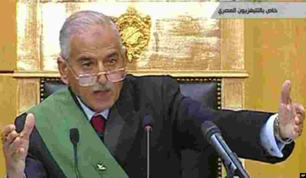 Video image taken from Egyptian State Television shows judge Ahmed Rifaat gesturing during the trial of former President Hosni Mubarak,  his two sons and other officials at the start of his historic trial in a Cairo courtroo. (AP Image)