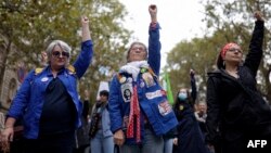 Protesters raise their fists during a demonstration rally organized by women's rights groups to defend the right to abortion, on International Safe Abortion Day in Paris, Sept. 28, 2024. 