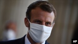 FILE - In this file photo dated Friday Sept. 4. 2020, French President Emmanuel Macron wears a mask during a ceremony to celebrate the 150th anniversary of the proclamation of the Republic, in Paris. 