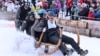 Competitors ride their wooden sledge during the traditional Bavarian horn sledge race 'Hornschlittenrennen' in Garmisch-Partenkirchen, Germany, Jan. 6, 2025. 