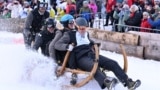 Competitors ride their wooden sledge during the traditional Bavarian horn sledge race 'Hornschlittenrennen' in Garmisch-Partenkirchen, Germany, Jan. 6, 2025. 