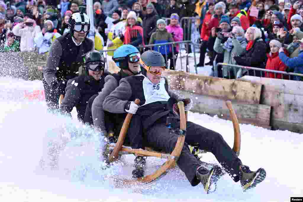 Competitors ride their wooden sledge during the traditional Bavarian horn sledge race &#39;Hornschlittenrennen&#39; in Garmisch-Partenkirchen, Germany.