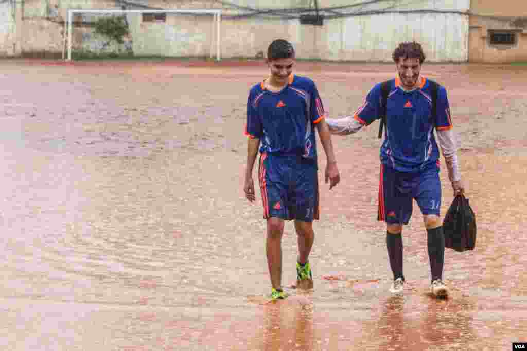 Players abandon a match before half time: The pitch, which is outside of Shatila, had become unplayable. (John Owens for VOA)